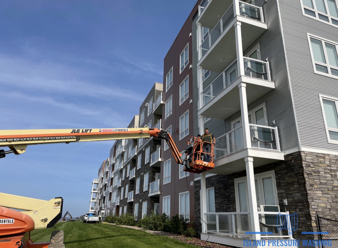 Window washing an apartment building in PEI