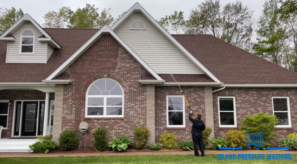 Pressure washing a house in PEI